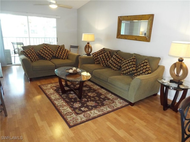 living room featuring wood-type flooring, lofted ceiling, and ceiling fan