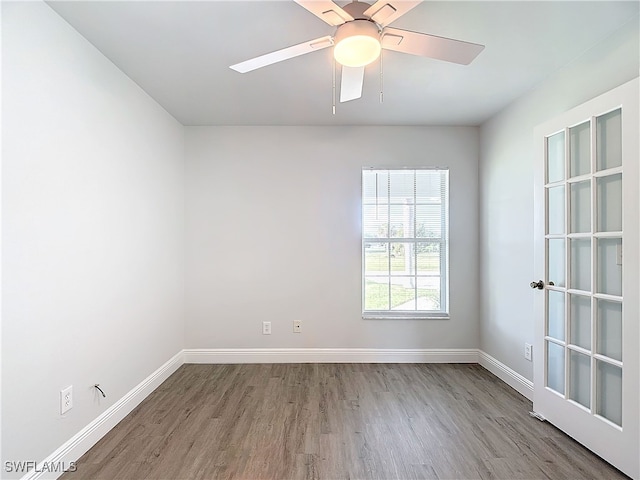 spare room featuring wood-type flooring and ceiling fan