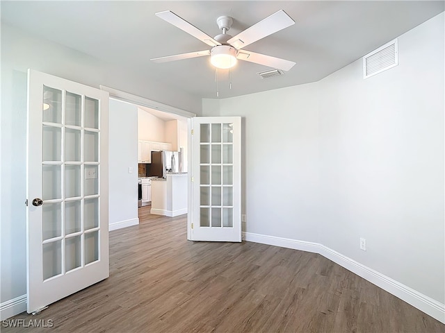 unfurnished room featuring light hardwood / wood-style flooring, french doors, and ceiling fan