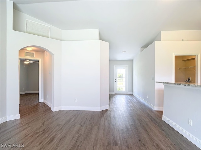 spare room featuring ceiling fan and dark wood-type flooring