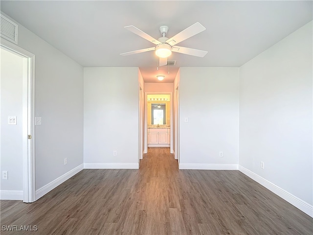 empty room with ceiling fan and wood-type flooring