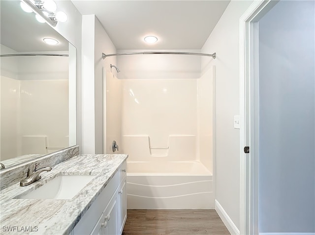 bathroom with vanity, shower / tub combination, and hardwood / wood-style floors