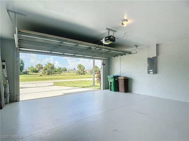 garage featuring electric panel and a garage door opener