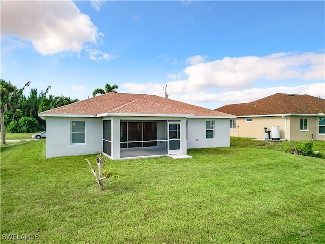 back of property featuring a lawn