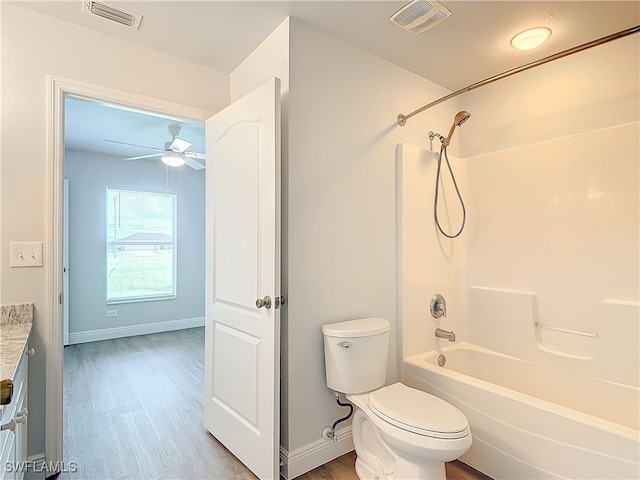 full bathroom featuring toilet, vanity, bathing tub / shower combination, ceiling fan, and wood-type flooring