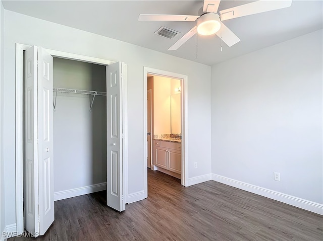 unfurnished bedroom featuring a closet, dark hardwood / wood-style flooring, and ceiling fan