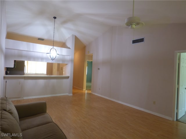 unfurnished living room featuring hardwood / wood-style flooring and high vaulted ceiling