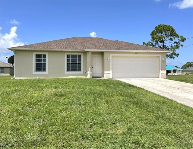 single story home featuring a garage and a front lawn