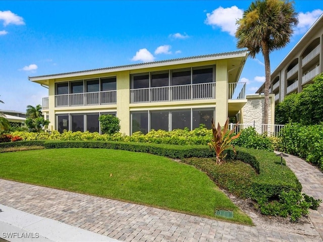 rear view of property with a yard