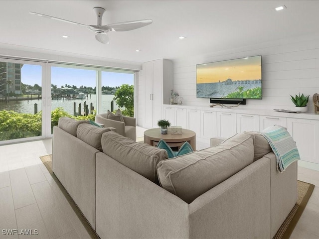 living room with ceiling fan and light wood-type flooring