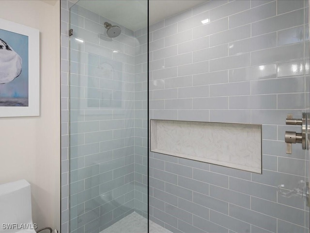 bathroom with tiled shower