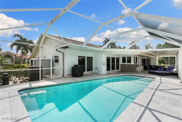 view of pool with a lanai and a patio area