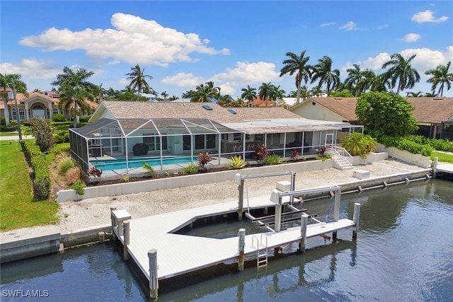 dock area with glass enclosure, a water view, and a patio