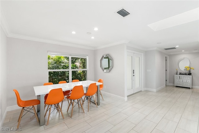 dining space with crown molding and a skylight