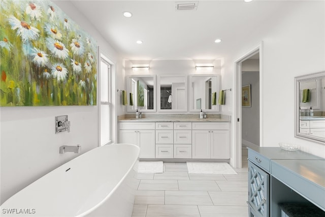 bathroom featuring vanity and a bathing tub