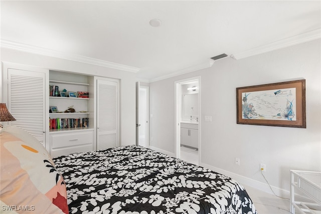 bedroom with ornamental molding and connected bathroom