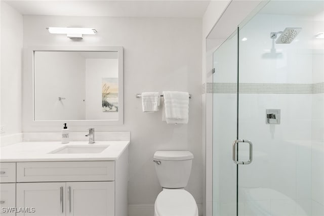 bathroom featuring vanity, toilet, and an enclosed shower