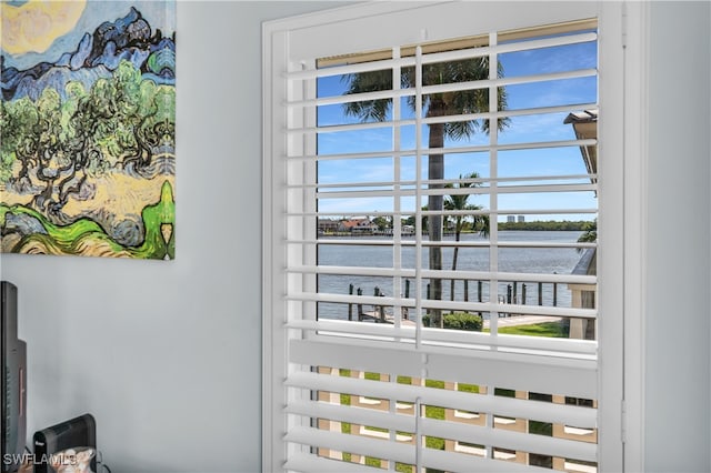 doorway to outside with a water view and a healthy amount of sunlight