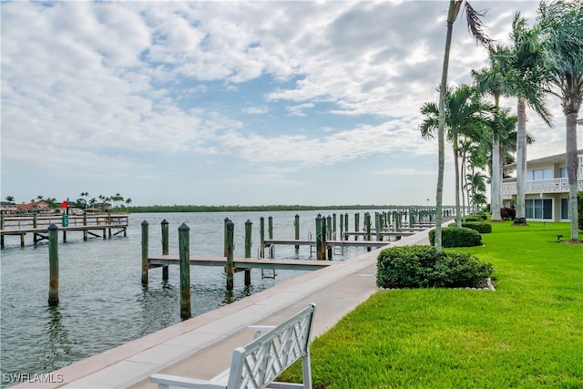 dock area with a water view and a lawn