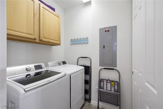 laundry room with light tile patterned flooring, washing machine and dryer, cabinets, and electric panel