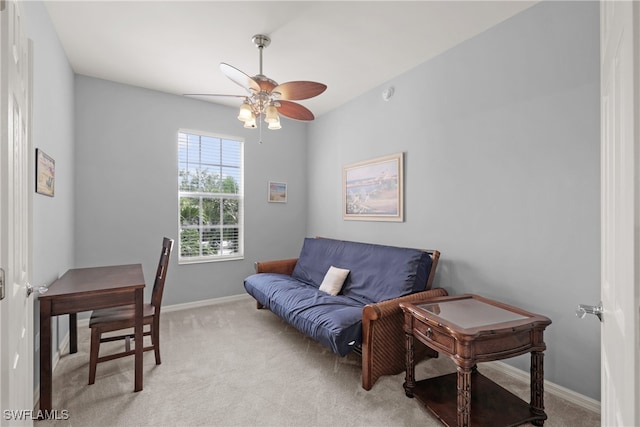 carpeted home office featuring ceiling fan