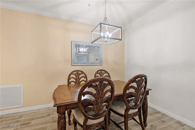 dining area with light hardwood / wood-style flooring, crown molding, and a notable chandelier