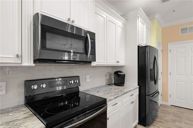 kitchen with decorative backsplash, light stone counters, crown molding, black appliances, and white cabinets