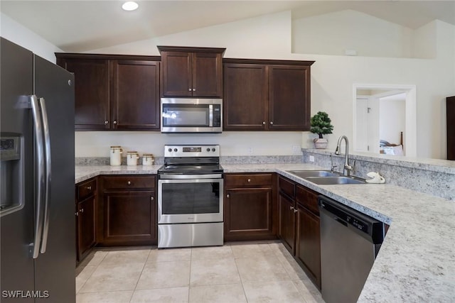 kitchen with sink, light tile patterned flooring, stainless steel appliances, and lofted ceiling