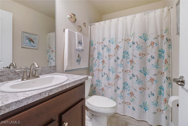 bathroom with vanity, a shower with shower curtain, and toilet