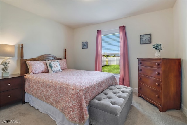 bedroom featuring light colored carpet