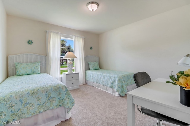 bedroom featuring light colored carpet