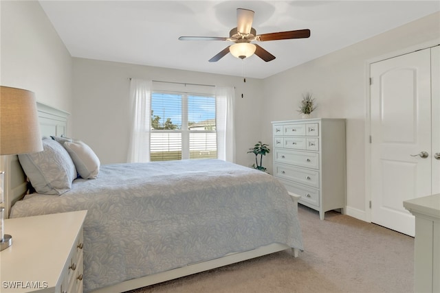 carpeted bedroom with ceiling fan and a closet