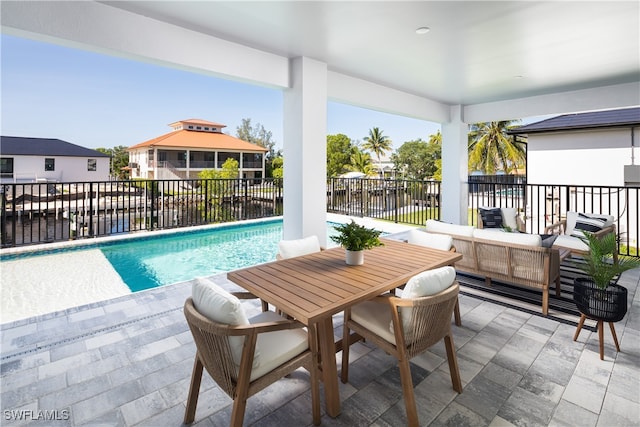 view of swimming pool with outdoor lounge area, a water view, a gazebo, and a patio