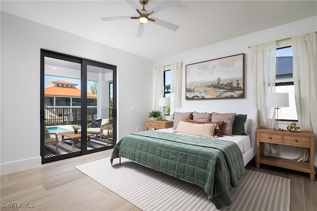 bedroom featuring light hardwood / wood-style floors, ceiling fan, and access to exterior