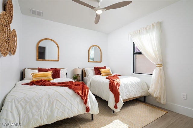 bedroom with ceiling fan and hardwood / wood-style flooring