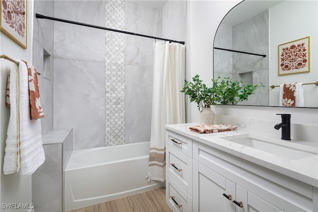 bathroom with wood-type flooring, shower / bath combo, and vanity