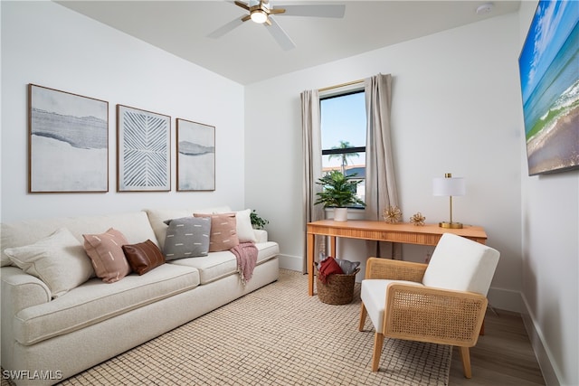 living room with light hardwood / wood-style floors and ceiling fan