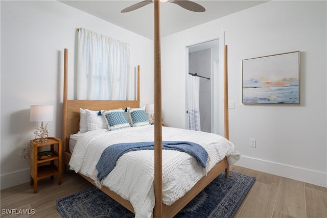 bedroom with light hardwood / wood-style floors and ceiling fan