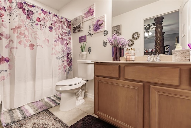 bathroom featuring toilet, tile patterned flooring, and vanity