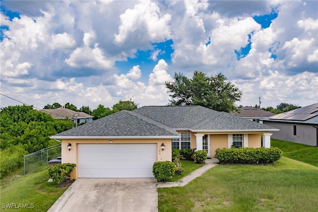 single story home with a garage and a front yard