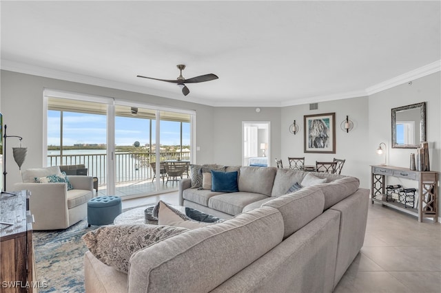 tiled living room featuring ceiling fan, a water view, and ornamental molding