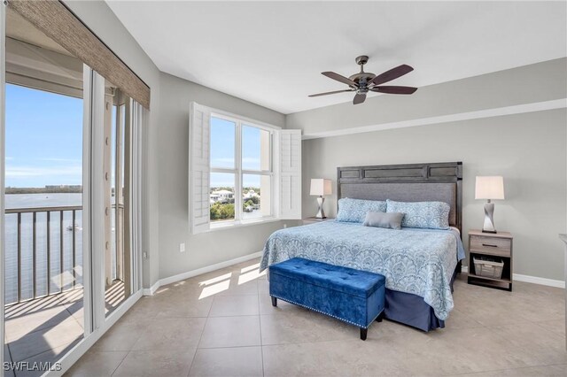 tiled bedroom featuring ceiling fan, access to exterior, and a water view