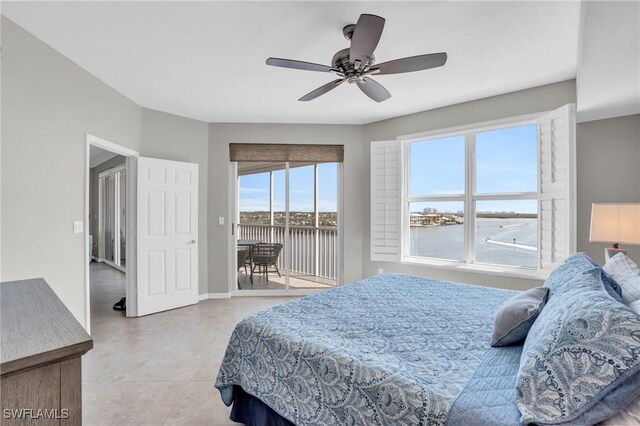 bedroom featuring ceiling fan, light tile patterned flooring, a water view, and access to exterior