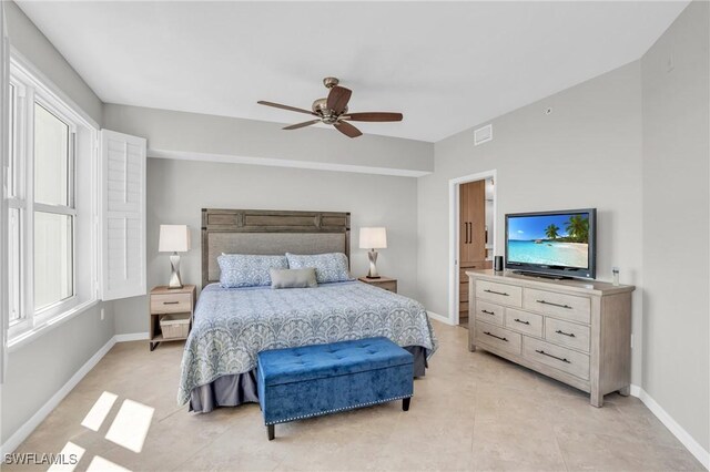 tiled bedroom featuring ceiling fan