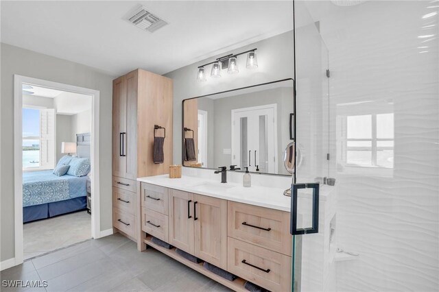 bathroom with tile patterned floors, vanity, and an enclosed shower