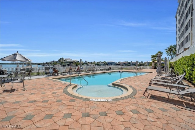 pool featuring fence and a patio