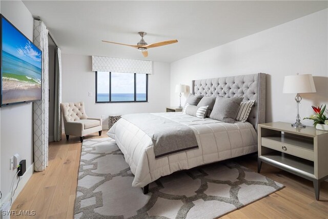 bedroom with a ceiling fan and light wood-type flooring