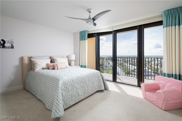 carpeted bedroom with ceiling fan, floor to ceiling windows, and access to exterior