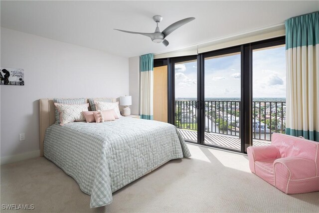 carpeted bedroom featuring access to exterior, baseboards, and a ceiling fan