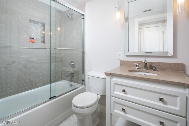 bathroom with enclosed tub / shower combo, visible vents, vanity, and toilet